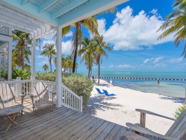 Beach House porch with Adirondack chairs overlooking the ocean