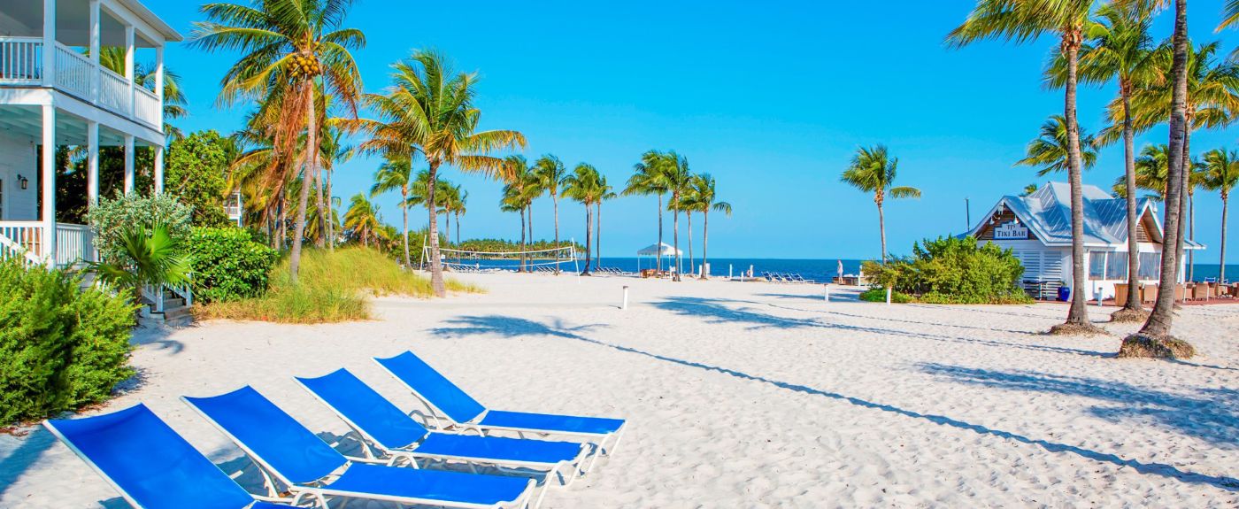 Lounge chairs on sandy beach