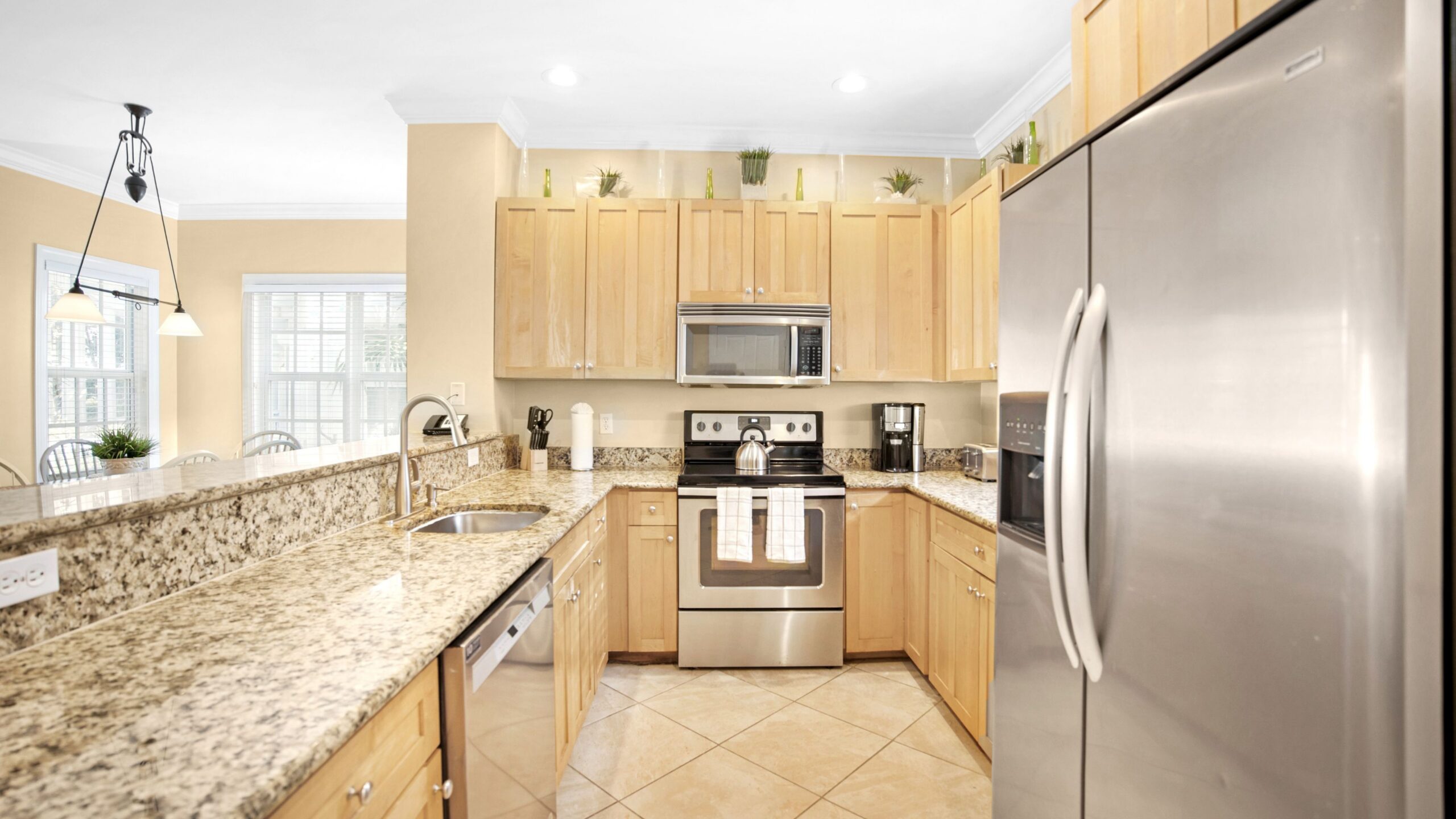 A full kitchen in a 3-Bedroom Beachfront Villa at Tranquility Beach Beachfront Resort, in the Florida Keys.