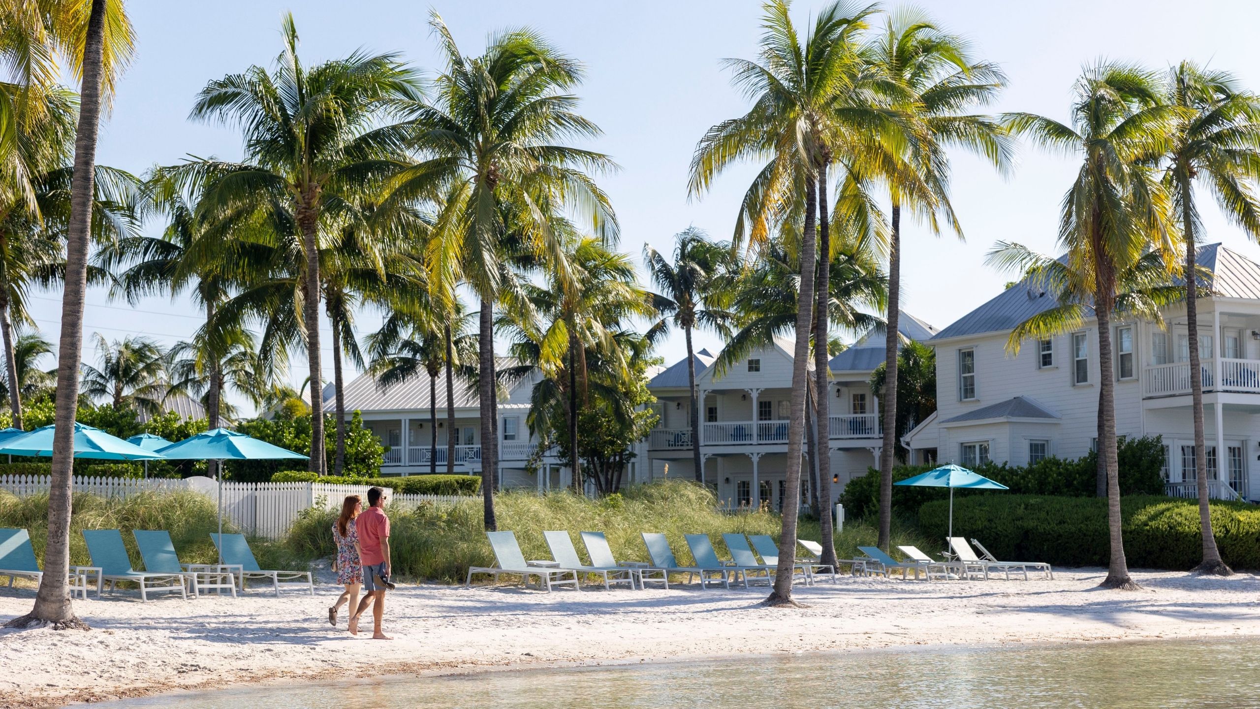 A couple walks on the private beach at Tranquility Bay Beachfront Resort, in Marathon, FL.