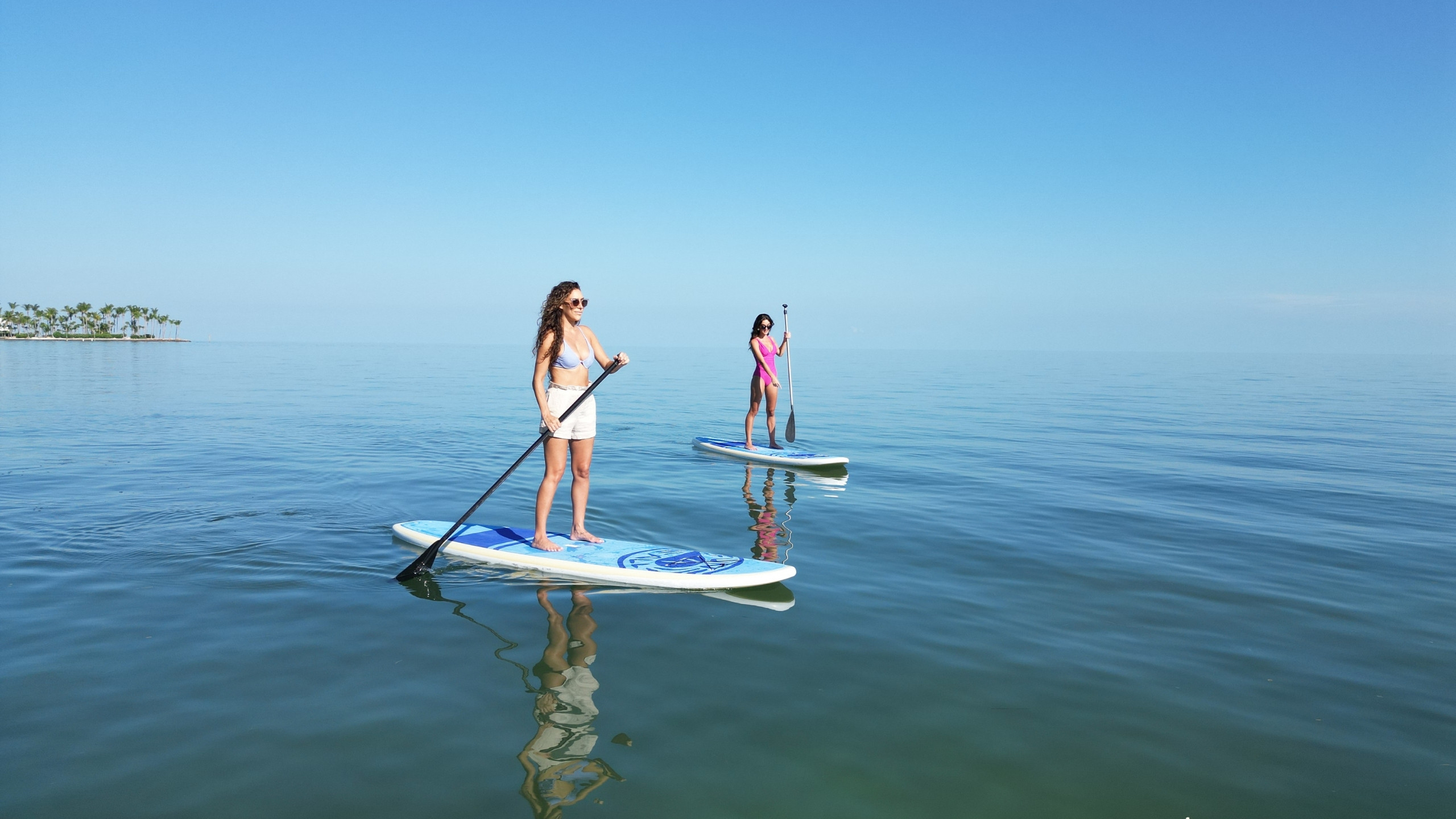 Guests using the standup paddleboards on the calm water at Tranquility Bay Beachfront Resort, in the Florida Keys.
