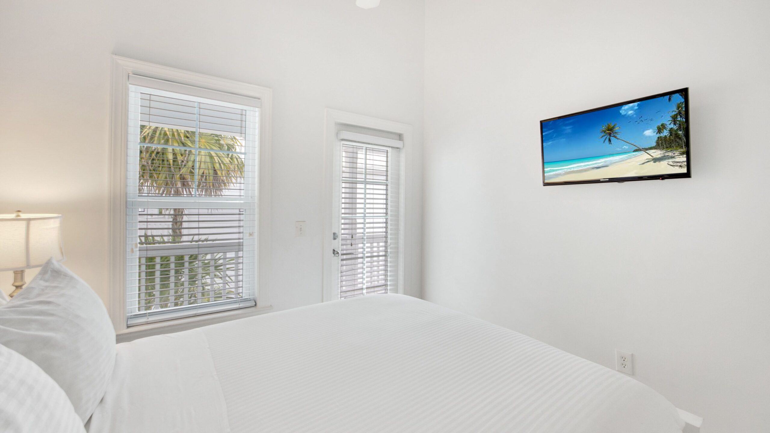 A queen bedroom in a 3-Bedroom Waterfront Villa at Tranquility Beach Beachfront Resort, in the Florida Keys.