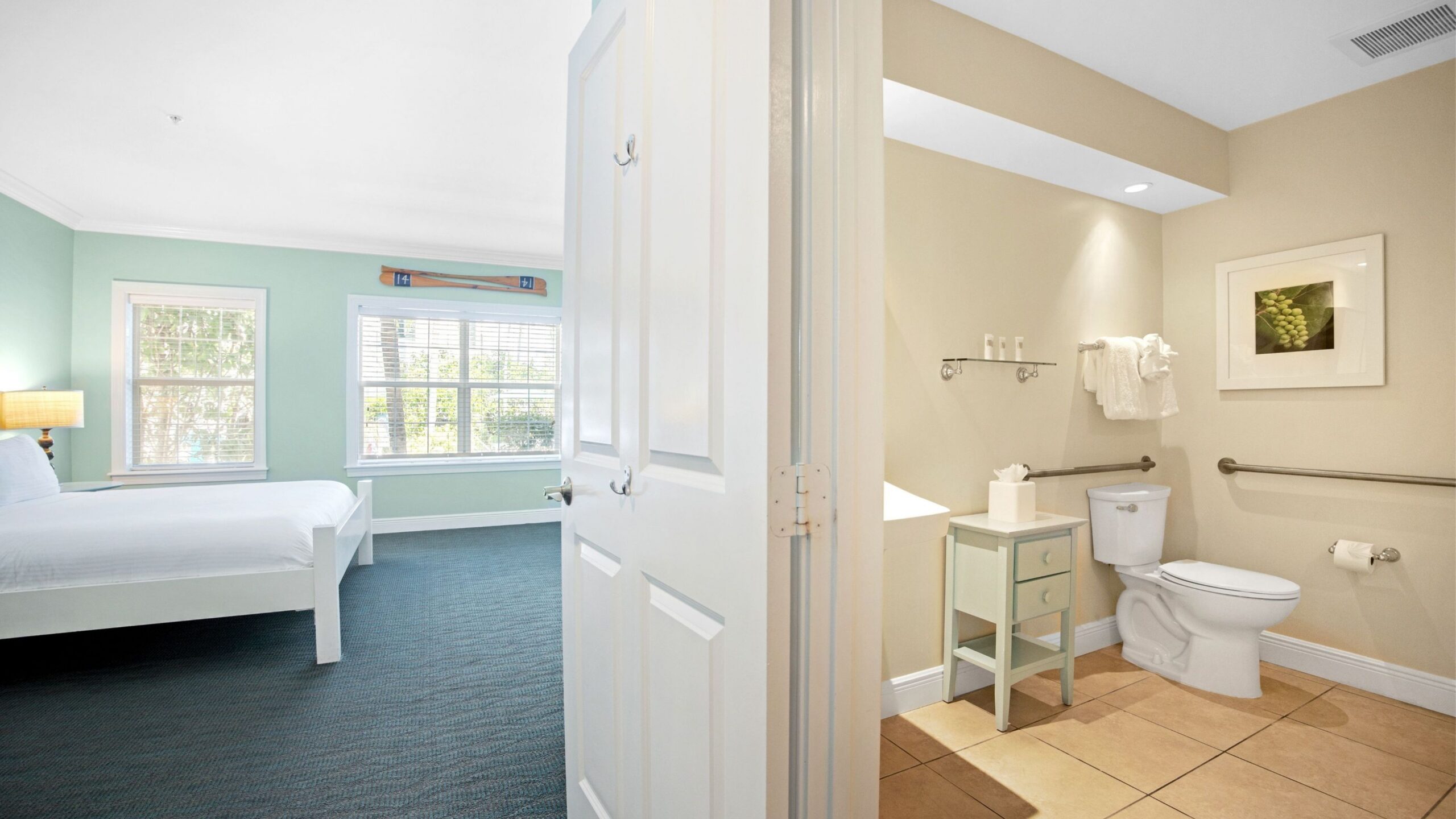 Bathroom and Bedroom of an Accessible Ground-Floor Tropical Garden King Hotel Room at Tranquility Bay Beachfront Resort, in the Florida Keys.