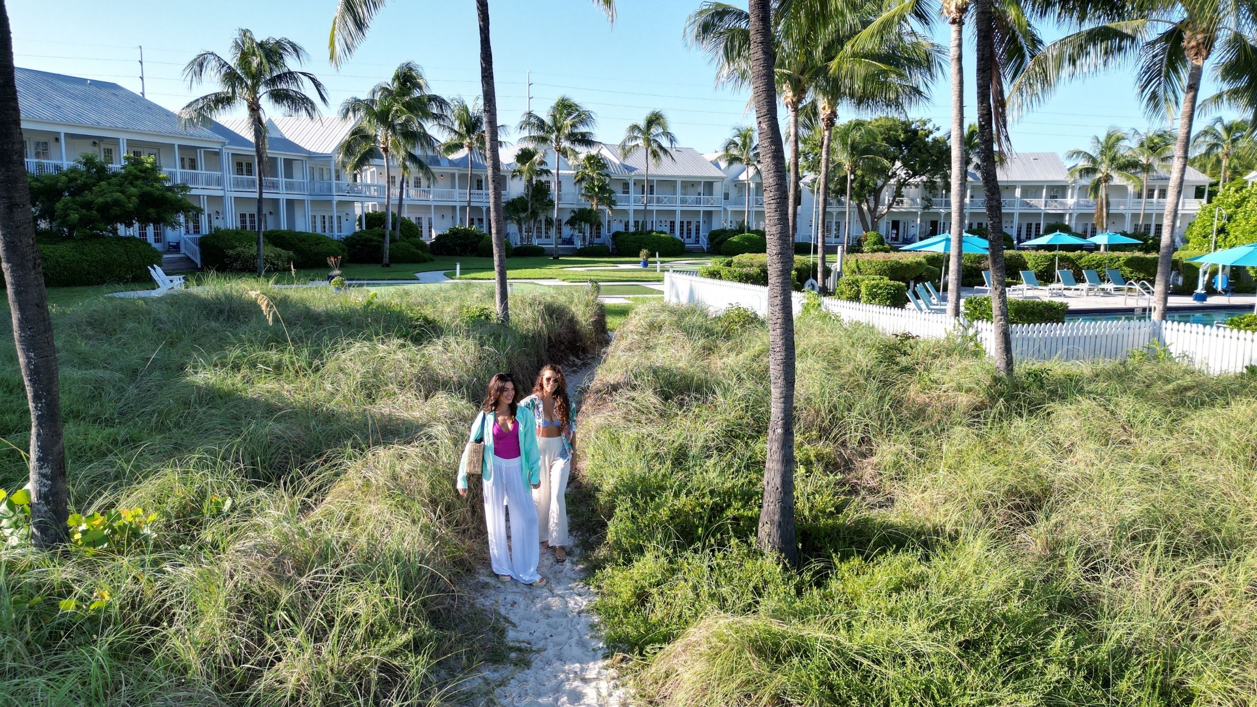 Women walking on a path at Tranquility Bay Beachfront Resort, in the Florida Keys.