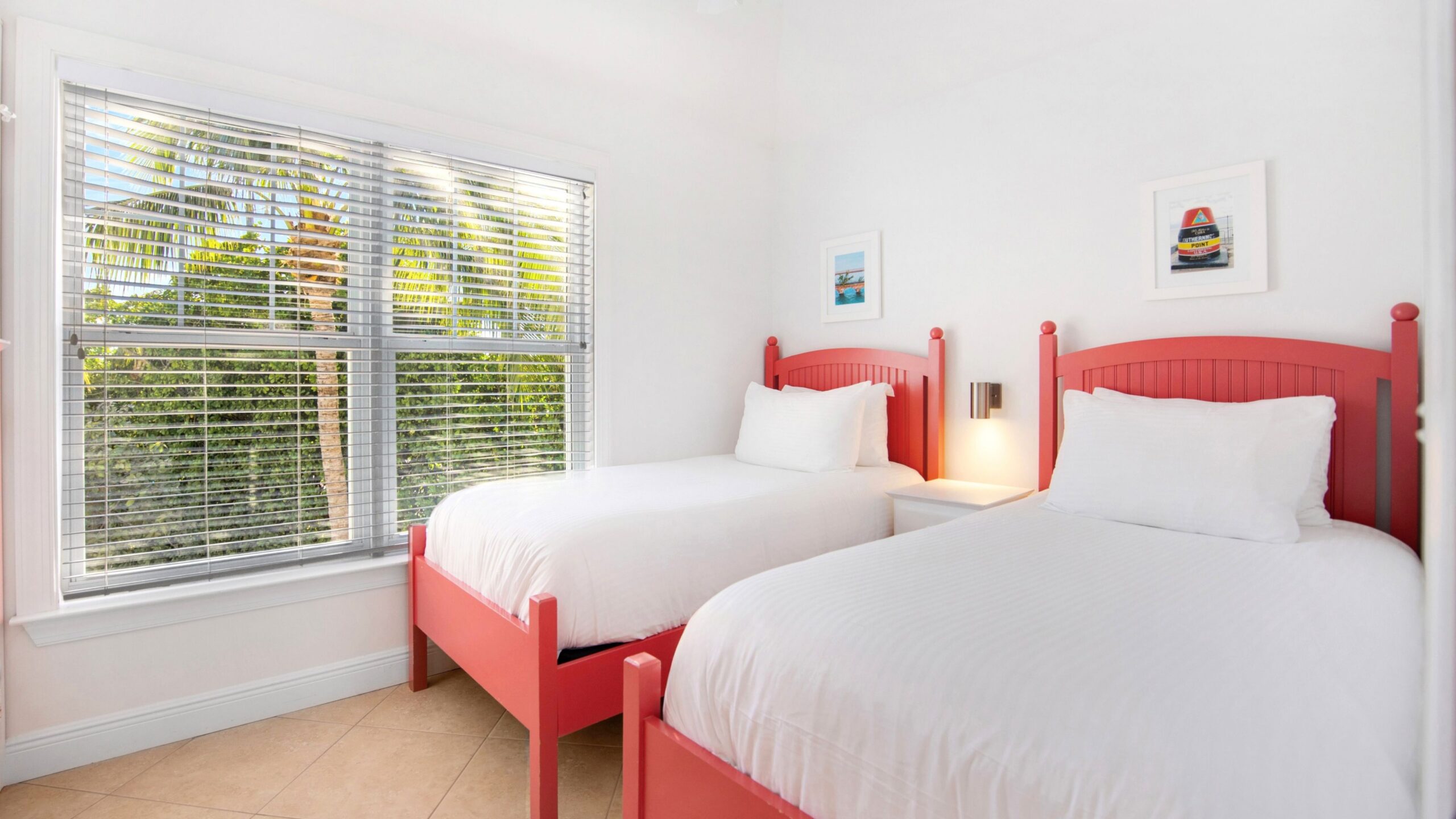 A bedroom with two twin beds in a 3-Bedroom Waterview Villa at Tranquility Bay Beachfront Resort, in Marathon, FL.
