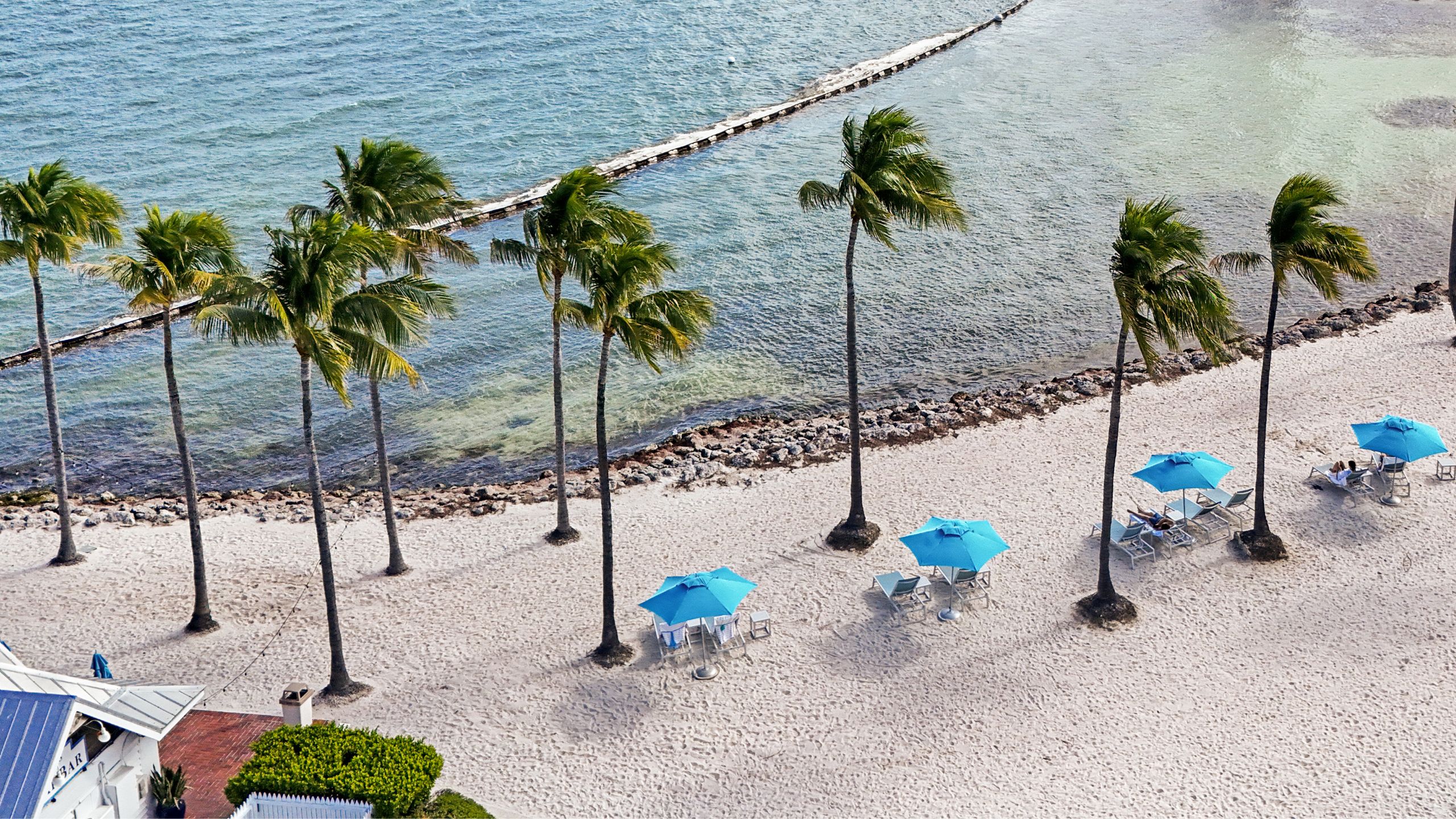 Aerial view of the beach umbrellas on the private beach at Tranquility Bay Beachfront Resort, in the Florida Keys.