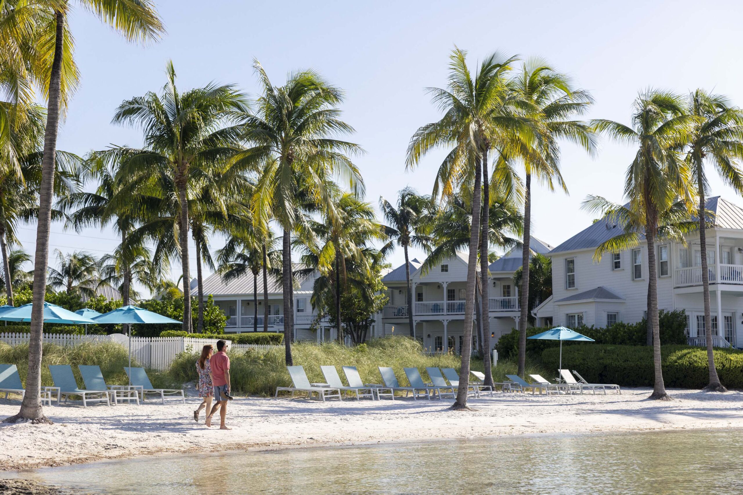 A couple walking on Tranquilily Bay's private beach
