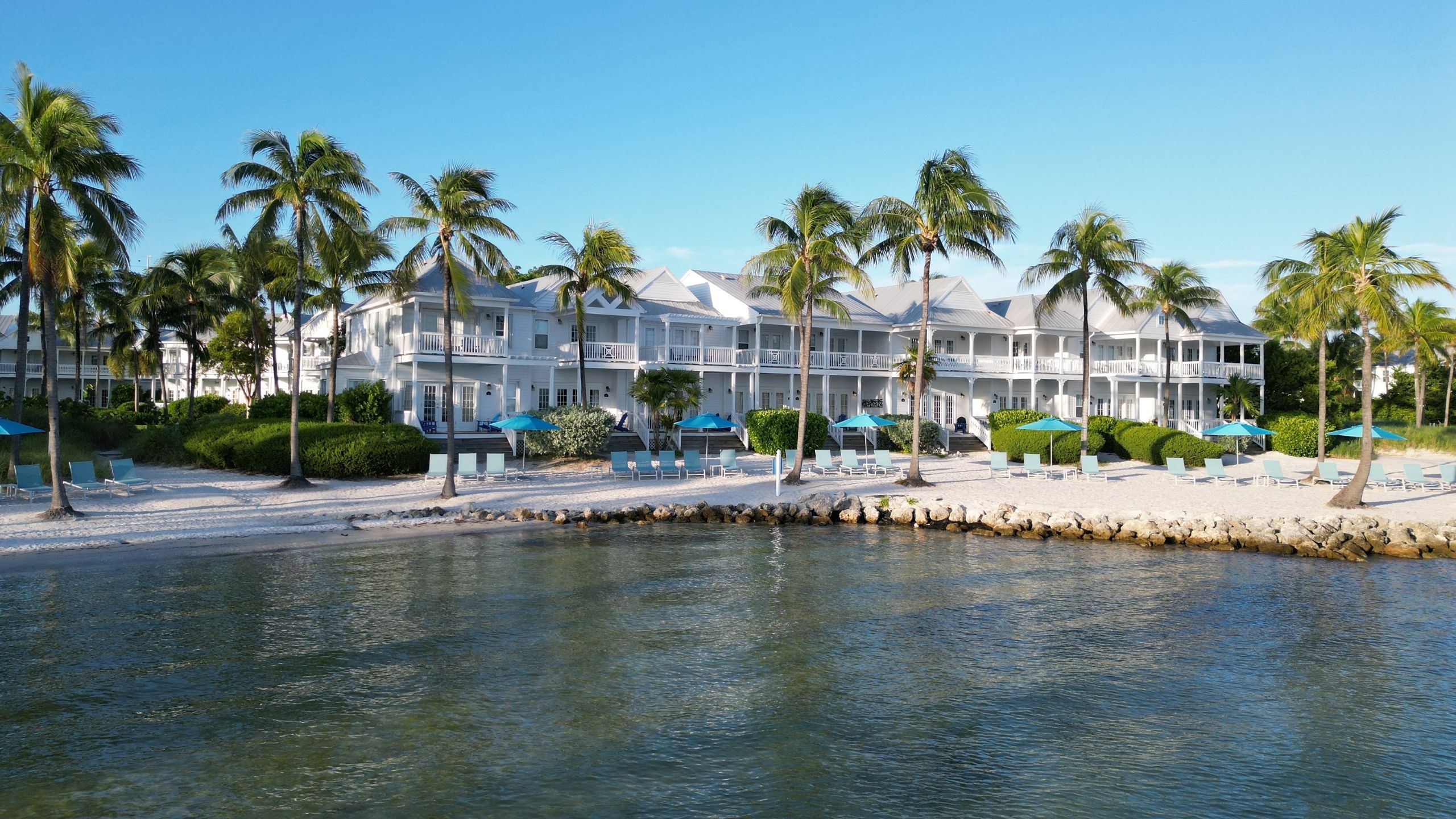 Tranquility Bay Beachfront Resort villa exteriors and private beach.